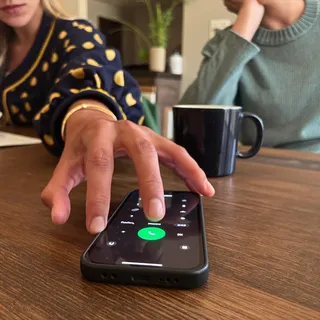 A hand answering a ringing phone