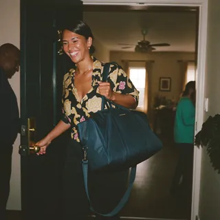 A person with a bag arriving at a house